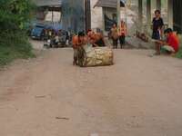 laos labour rolling up gas tank Pakbeng, South East Asia, Laos, Asia